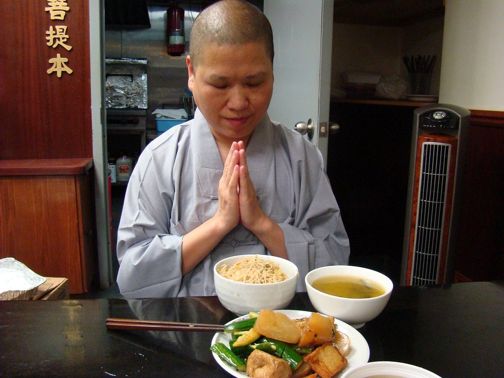 Buddhist man prays before eating – Photo by Ramaa Raghavan
